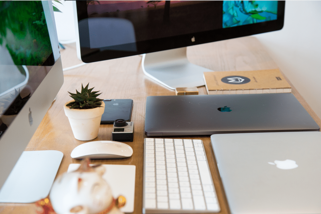Modern Apple workspace with laptop and desktop computer